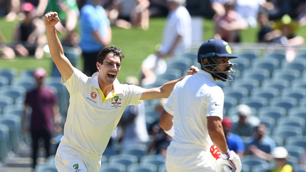 Huge wicket: Pat Cummins celebrates the dismissal of Virat Kohli as Australia get out of the blocks fast in the first Test.
