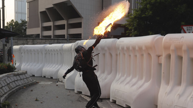 An anti-government protester throws a Molotov cocktail during a demonstration near the Central Government Complex in Hong Kong.