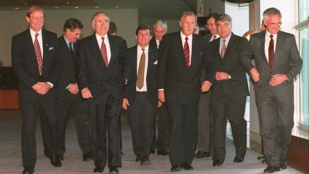 John Howard leads the State Police Ministers to the conference room to discuss gun law reform.