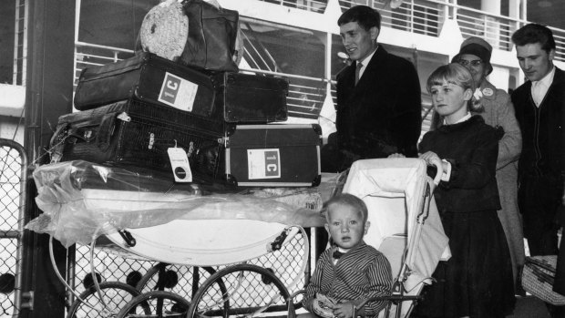 A British family wheel their luggage off a ship after arriving in Port Melbourne in February 1964. 