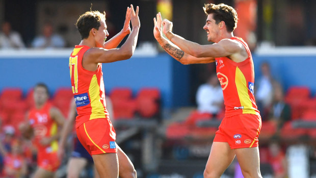 Rising Suns: Alex Sexton (right) and Will Powell celebrate a goal against the Dockers.