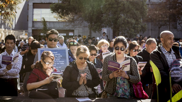 Melburnians gathered in prayer in the sun at one of the stations of the cross.  