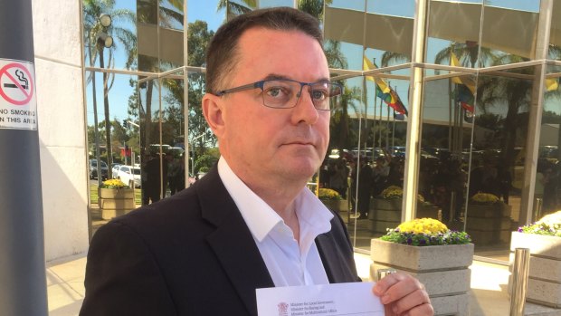 Logan mayor Luke Smith with the letter from Local Government Minister Stirling Hinchliffe, which formally suspended him on Tuesday, May 22, 2018.