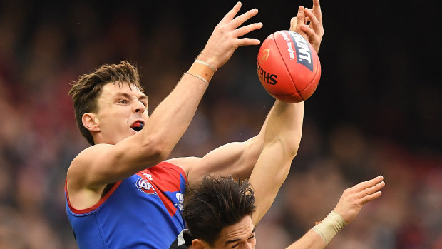 Jake Lever flies for the grab during the Demons' 109-point win over the Blues on Sunday.