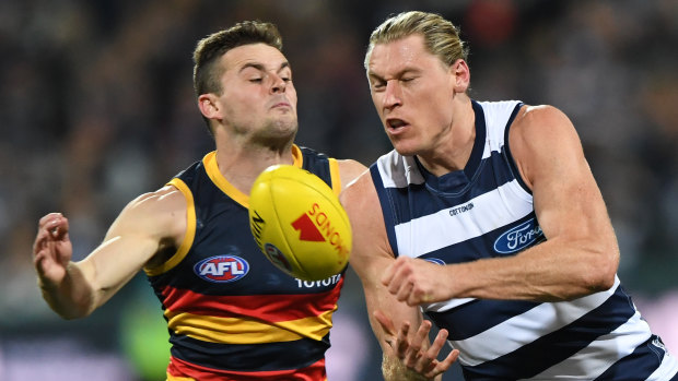 Adelaide's Brad Couch and Geelong's Mark Blicavs contest possession.