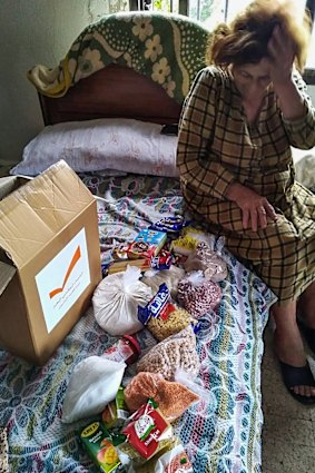 A woman in Beirut receives goods provided by the United Australian Lebanese Movement.