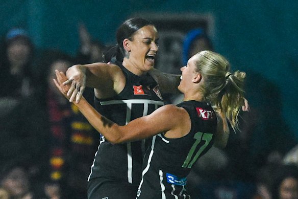 Gemma Houghton of the Power and Ella Boag of the Power celebrate at the final siren.