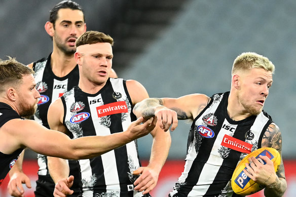Collingwood's Jordan De Goey, right, has been charged with indecent assault. 
