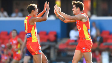 Rising Suns: Alex Sexton (right) and Will Powell celebrate a goal against the Dockers.