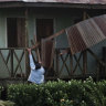 A woman works to recover a roof part damaged by hurricane Eta in Wawa, Nicaragua.