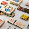 Matchbooks promoting former Brisbane businesses, from the collection of Donat Taharij in the exhibition Precious at the Museum of Brisbane.