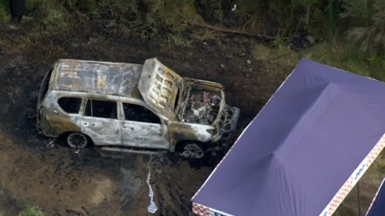 Stills from footage of the scene where a burnt out car, believed to be involved in the fatal shooting in South Yarra overnight, was dumped. 