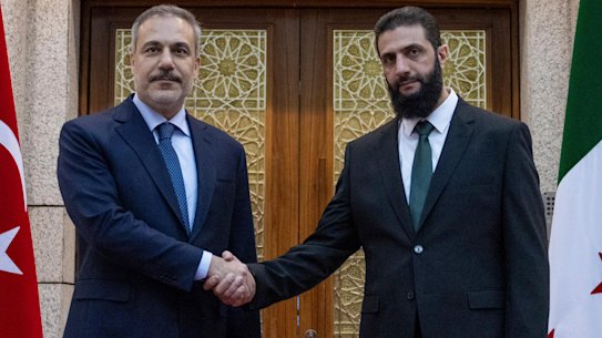 Turkish Foreign Minister Hakan Fidan, left, shakes hands with Ahmad al-Sharaa, formerly known as Abu Mohammed al-Jolani during their meeting in Damascus, Syria, on Sunday.