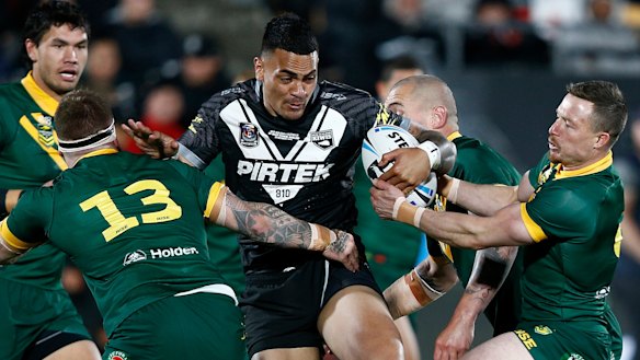 Out of my way: Ken Maumalo makes a run at the Australian defence.