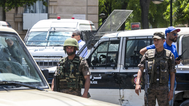 Tunisian soldiers stand guard after an explosion in Tunis.