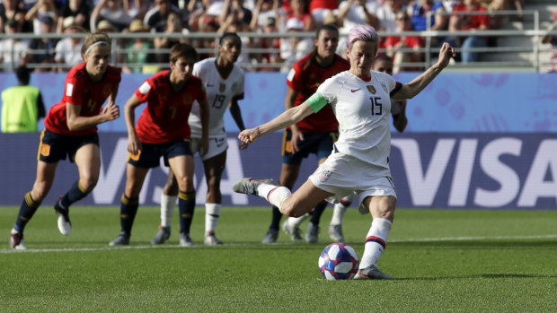 Spot on: Rapinoe scores her side's second goal from a penalty.