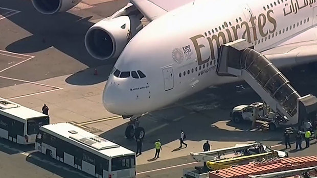 A person walks off the Emirates plane at JFK International Airport.