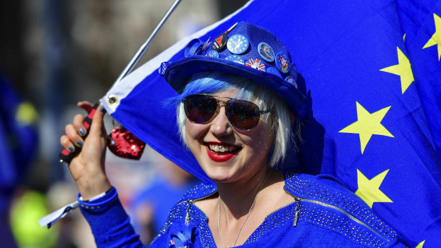 Madeleina Kay, Young European of the Year 2018 dressed in blue holds an EU flag and entertains the public while singing about Brexit outside the Houses of Parliament in Westminster, London, ahead of the latest round of debates.