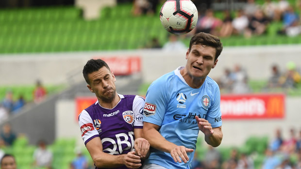 Eyes wide shut: Perth's Joel Chianese goes up against Curtis Good of Melbourne City.