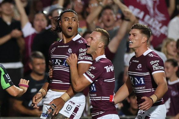 Haumole Olakau’atu celebrates with teammates after scoring the opening try.