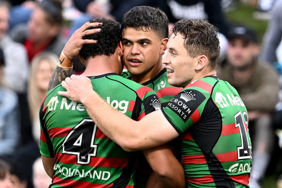 Latrell Mitchell celebrates scoring a try with Rabbitohs teammates.