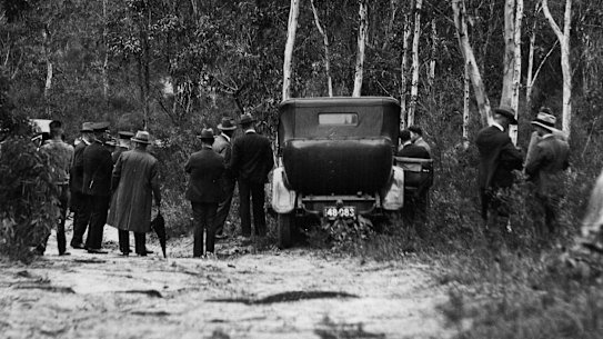 Manhunt ... Police set out to search bushland at Milperra following the discovery of the bodies.