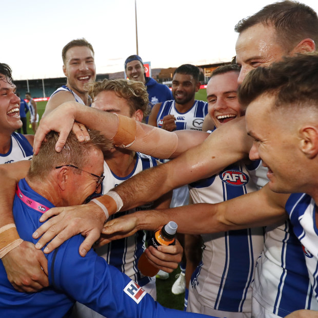 Kangaroos coach David Noble celebrates a win with his players in 2021. 