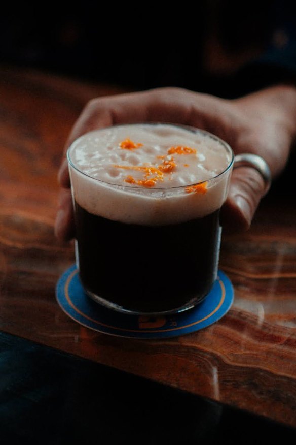 The Midnight Cowboy cocktail with vodka, Jamaican rum, coffee, orange, coconut and cardamom foam.