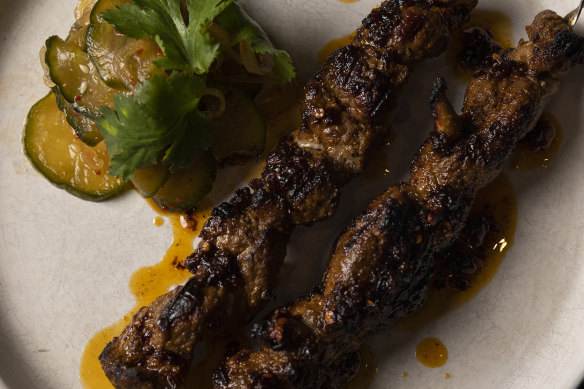  Xinjiang lamb skewers with Sichuan chilli oil and cucumber salad.
