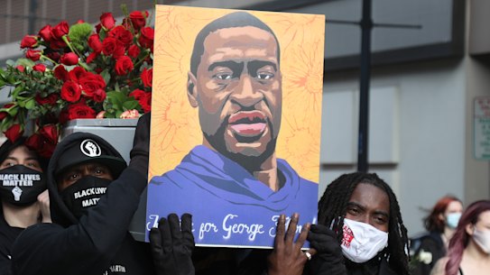 Demonstrators carry a symbolic coffin and images of George Floyd during an ‘I Can’t Breathe’ Silent March For Justice in Minneapolis, Minnesota, ahead of the trial.