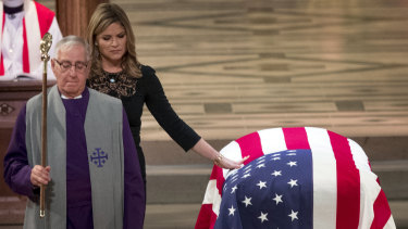 Jenna Bush Hager, the daughter of former president George W. Bush, touches the casket of her grandfather, former president George H.W. Bush, after speaking at his state funeral.
