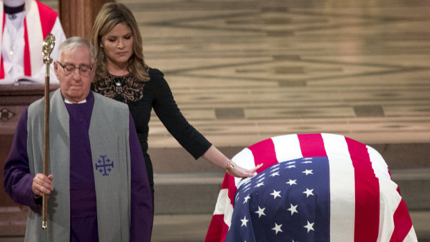 Jenna Bush Hager, the daughter of former president George W. Bush, touches the casket of her grandfather, former president George H.W. Bush, after speaking at his state funeral.