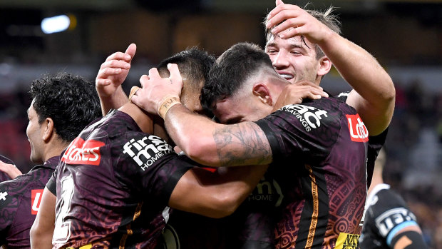 Darius Boyd and the Broncos celebrate a try on Friday night.