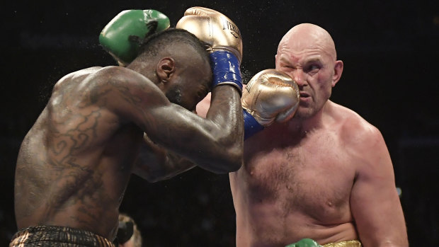 Hit and cover: Deontay Wilder, left, connects with Brit Tyson Fury during their WBC heavyweight championship bout.