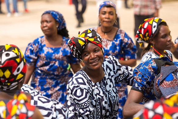 Women in Angola greet the arriving train.
