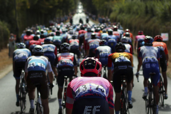 Hugh Carthy, in the pink jersey, competed at the Tour de France before starting the Vuelta a Espana. 