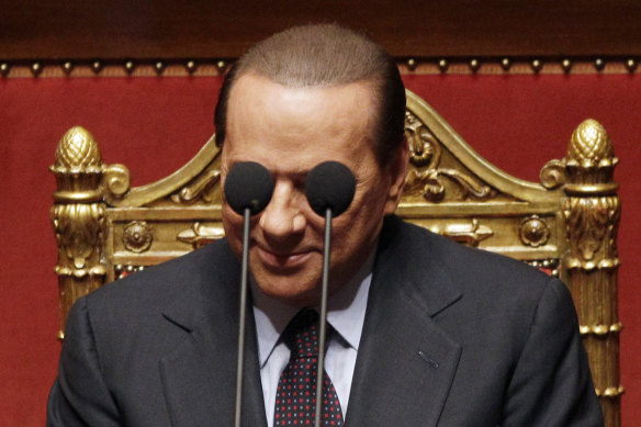 Berlusconi framed by microphones in the Italian Senate in 2010. 