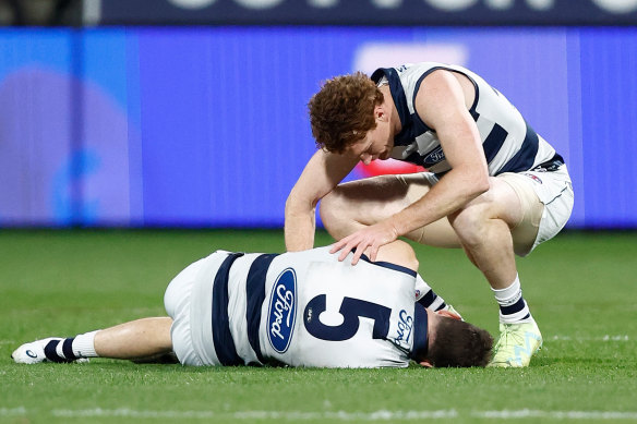 Jeremy Cameron was taken to hospital after the clash with teammate Gary Rohan (crouching).