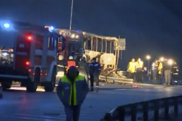 This image made from video provided by Nova TV shows emergency service workers beside a burnt-out bus in Bosnek, Bulgaria.