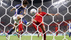Ao Tanaka of Japan scores the team’s second goal past Rodri of Spain.