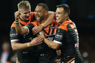 Benji Marshall in action for the Tigers, and with his halves partner Luke Brooks (right).