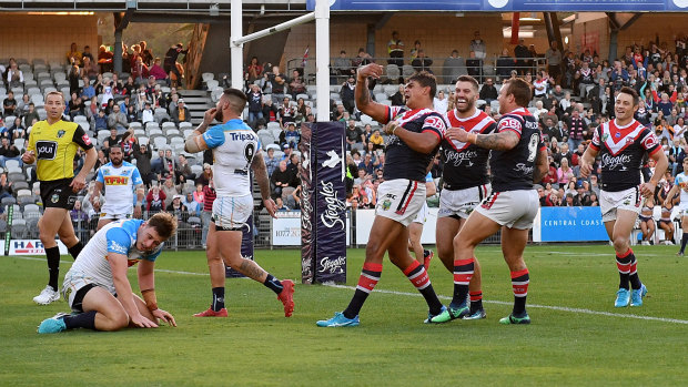 Latrell Mitchell of the Roosters celebrates with team mates after scoring a try.