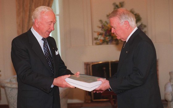 Commissioner James Staunton (left) hands the CAA and Seaview Air Commission of Inquiry report to the Governor-General Sir William Deane at Government House in Canberra in 1996.