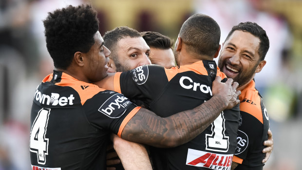 Reunited: Benji Marshall and Robbie Farah in the middle of a Tigers huddle in Farah's return game for the Leichhardt outfit.