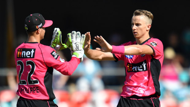 Celebrations: Tom Curran takes Chris Lyons' wicket in Queensland on New Years Day.