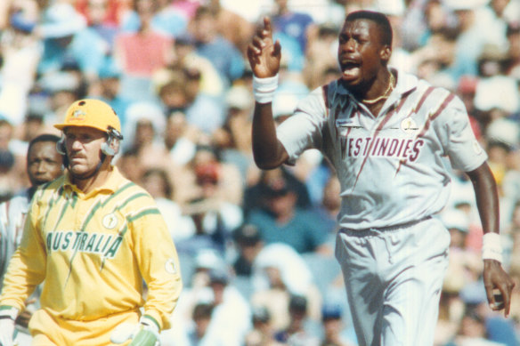 Curtly Ambrose and the famous sweatbands, with Allan Border watching on.