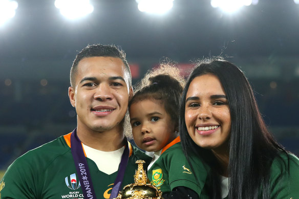 Cheslin Kolbe shares the trophy win his daughter, Kylah, and wife, Layla.