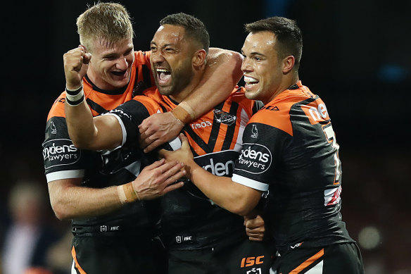 Benji Marshall in action for the Tigers, and with his halves partner Luke Brooks (right).