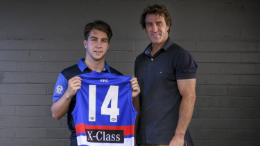 Rhylee West, with his father Scott West, could make his debut on Sunday against the Magpies.