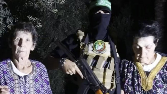 Hostages Yocheved Lifshitz, 85, centre, and Nurit Cooper, 79, are released by Hamas.